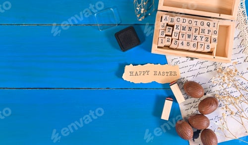 Preview: easter composition. chocolate eggs, letters for a stamp, a letter on the blue background.