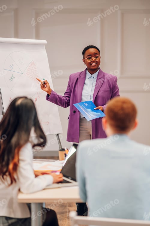 Preview: African american businesswoman holding a presentation during a meeting in an office