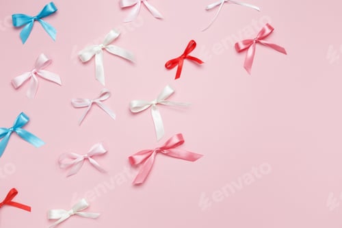 Preview: Multicolored bows on pink background. Top view, copy space
