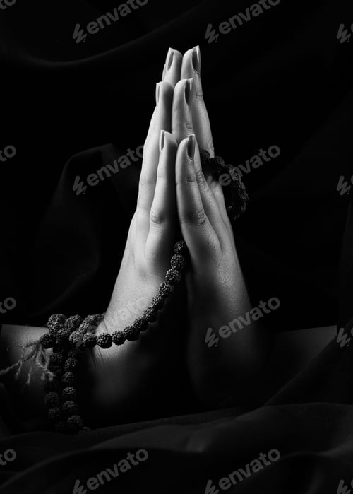Preview: Vertical shot of a religious Christian hands sign on a black background