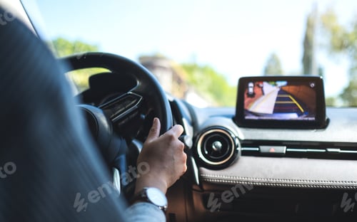 Preview: Closeup image of a woman holding steering wheel while driving a car on the road