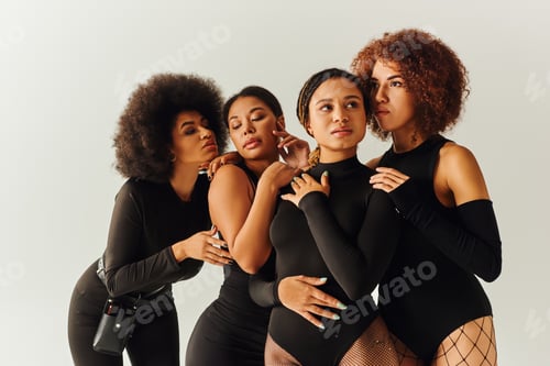 Preview: appealing sexy african american women in black stylish bodysuits posing together, fashion concept