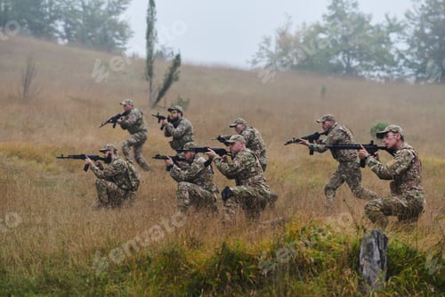 Preview: A disciplined and specialized military unit, donned in camouflage, strategically patrolling and