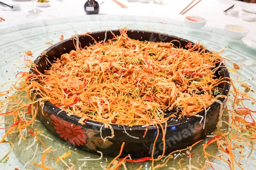 Preview: The food mess on table resulting from tossing and mixing yusheng during Chinese New Year meal is