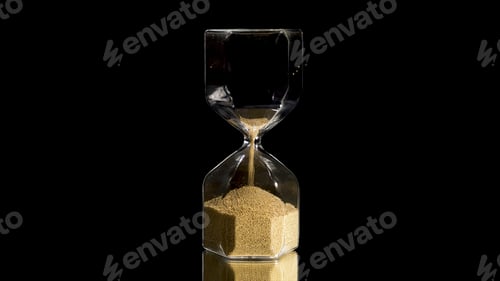 Preview: Elegant and stylish bronze transparent sandglass with trickling golden round particles. Stock