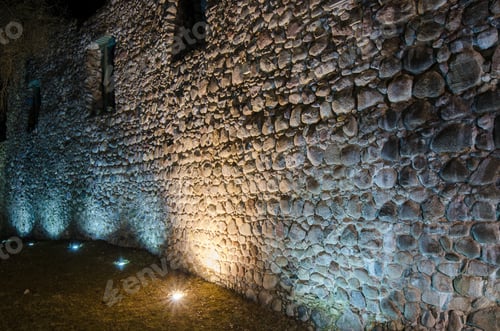 Preview: Candlelight row at an ancient fortress wall.