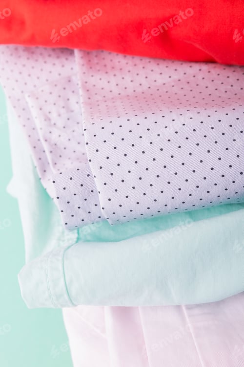 Preview: Stack of bright female trousers.