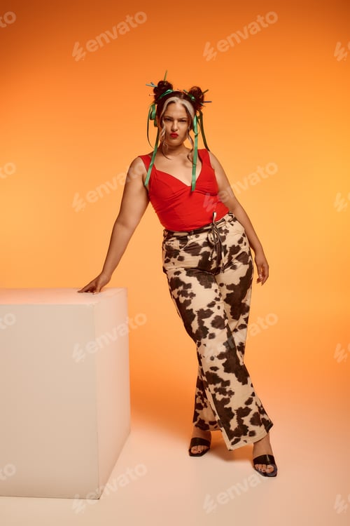 Preview: Young woman with Waardenburg syndrome embraces unique style on bold orange backdrop