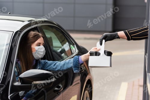 Preview: driver in medical mask taking coffee to go from cashier