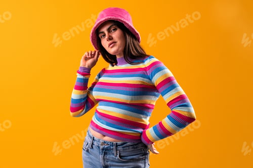 Preview: Young woman showcasing unique fashion style in studio