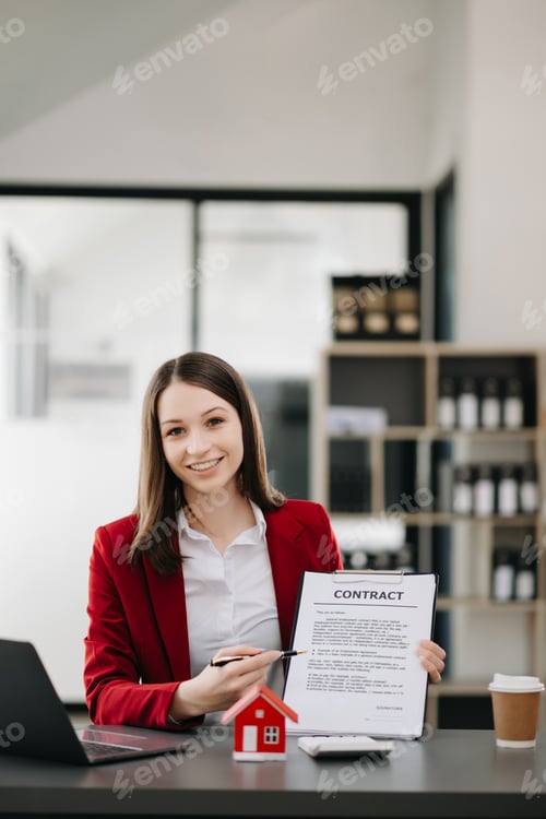 Preview: Young real estate agent worker working with laptop and tablet at table