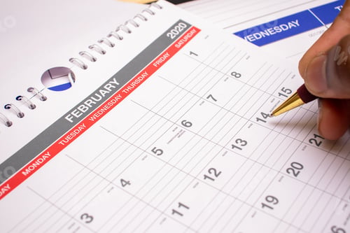 Preview: Events and planning, African American man writing on February 2020 calendar