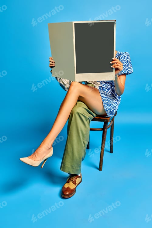 Preview: Combination of man and woman. Unisex person sitting in chair and reading newspaper