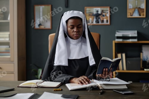 Preview: Nun Reading Holy Book in Office