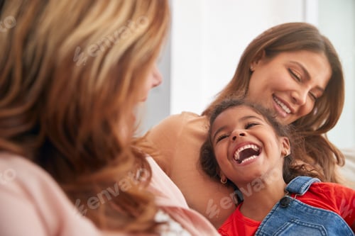 Preview: Multi-Generation Female Hispanic Family Relaxing On Sofa At Home