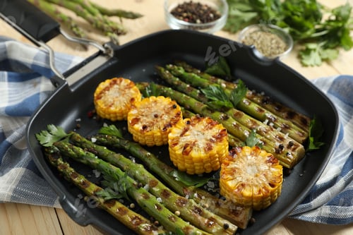 Preview: Delicious grilled vegetables with spices in pan on table, closeup