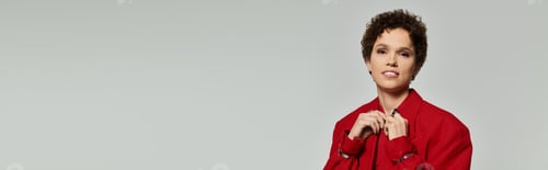 Preview: Beautiful young woman showcases fashion in striking red attire in modern studio setting
