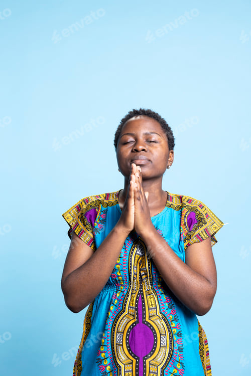 Preview: African american adult talking to Jesus Christ by saying grace