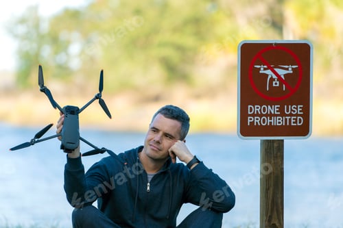 Preview: Operator is preparing to fly his quadcopter in national park no drone area.