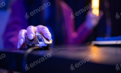 Preview: Close-up of a hand holding a gaming mouse during active computer use in a neon-lit environment