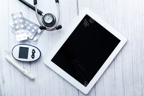 Preview: top view of digital tablet, pills and diabetic measurement tool on table