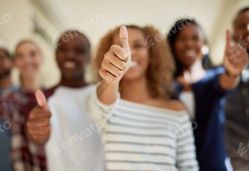 Preview: Shot of a diverse group of students showing thumbs up at campus