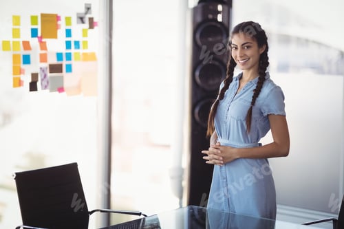 Preview: Female professional standing next to glass table with colorful sticky notes and speaker in office
