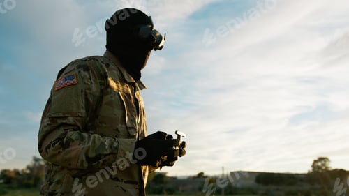 Preview: Man In Military Uniform With VR Headset Pilots A Drone Outdoors To Missiles