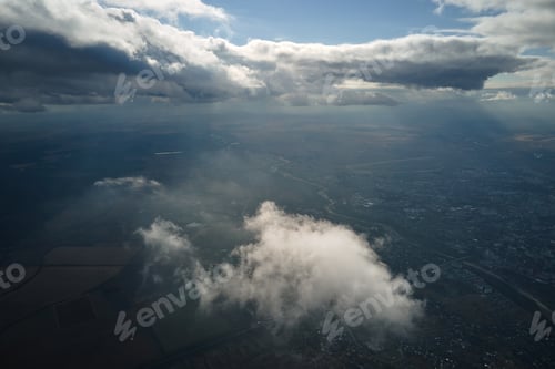 Preview: Aerial view at high altitude of earth covered with puffy cumulus clouds forming before rainstorm