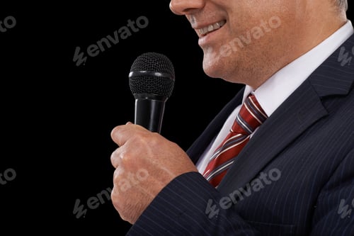 Preview: He has the gift of the gab. Cropped image of a mature man in a suit speaking into a microphone.