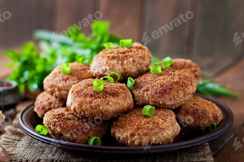 Preview: Juicy delicious meat cutlets on a wooden table in a rustic style.