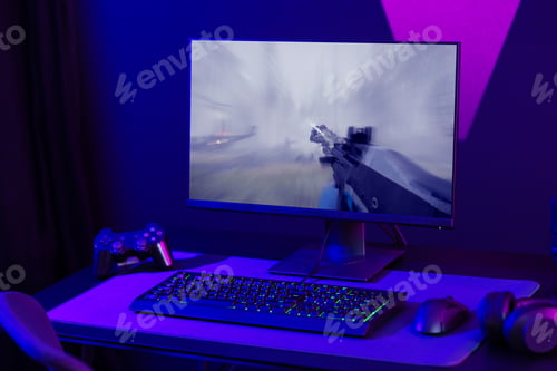 Preview: Immersive gaming setup with monitor, keyboard, and controller in a neon-lit room