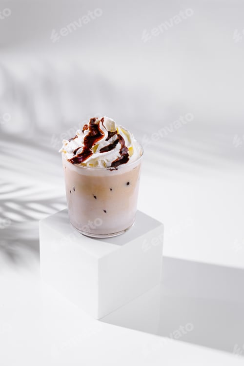 Preview: Iced coffee with whipped cream and chocolate sauce on white background