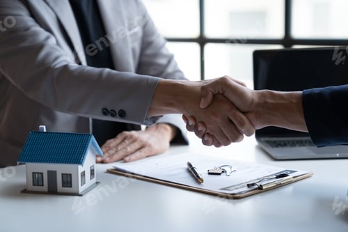 Preview: Two young Asian businessmen shake hands after signing a contract to invest in a village project. rea