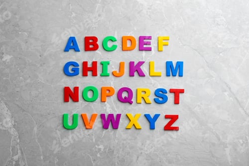 Preview: Colorful magnetic letters on light grey marble background, flat lay. Alphabetical order
