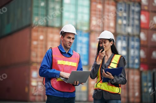 Preview: Workers collaborate at shipping yard discussing logistics and shipments in daylight