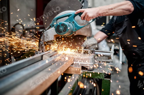Preview: man, worker using a sliding compound mitre saw with circular blade
