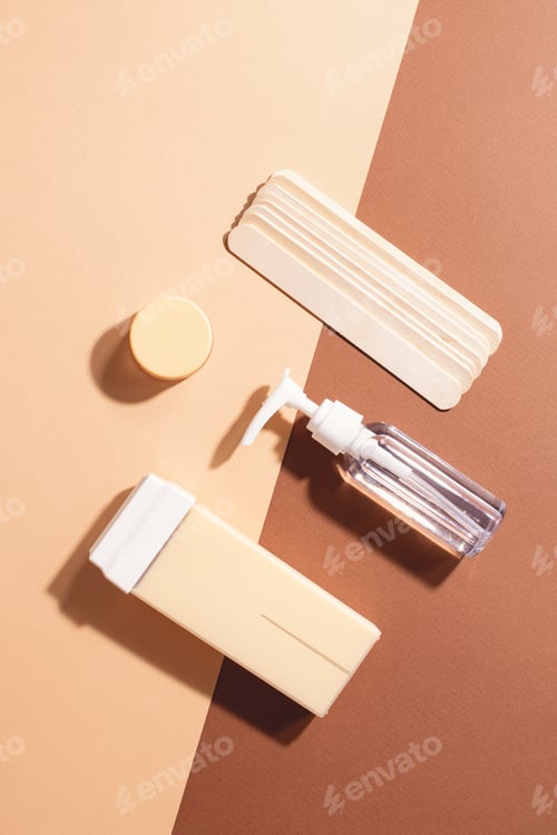 Preview: Top view of depilation tools on a beige brown background.