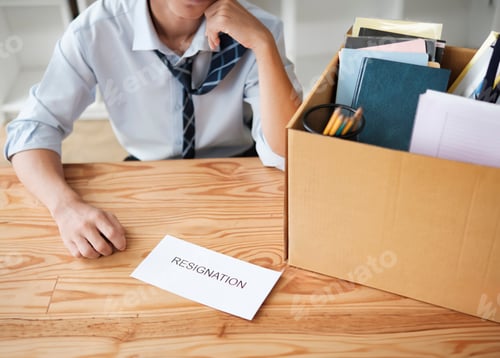Preview: Disappointed Businessman Holding Resignation Letter and Packing Belongings
