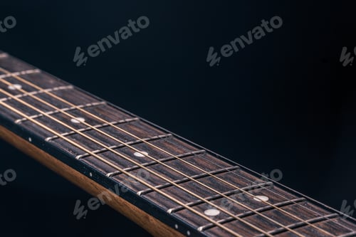 Preview: Close-up of an acoustic guitar fretboard copy space.