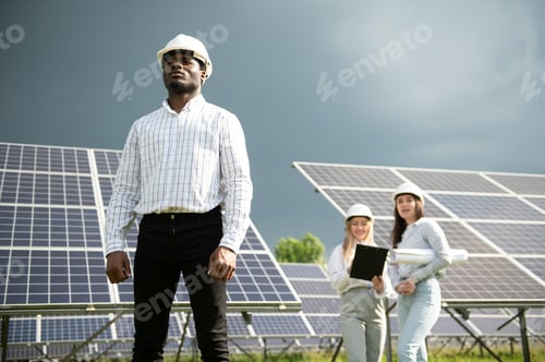 Preview: Male and female engineers worker working in solar panels power farm.