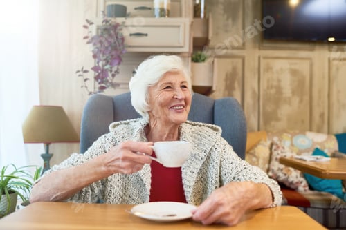 Preview: Senior Woman Relaxing with Tea Indoors