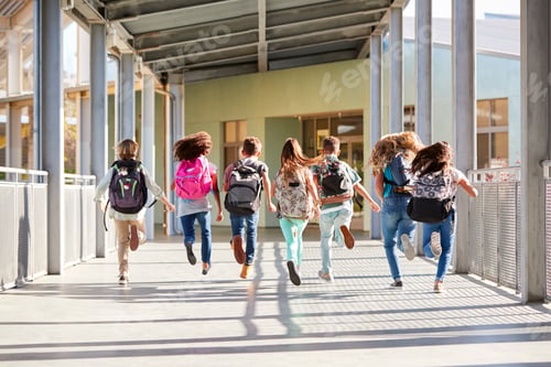 Preview: Elementary school kids running at school, back view close up