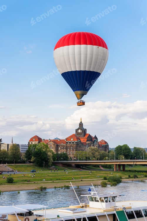 Preview: Hot air balloon with people tourist flying over Elbe river in Dresden Saxony State Chancellery