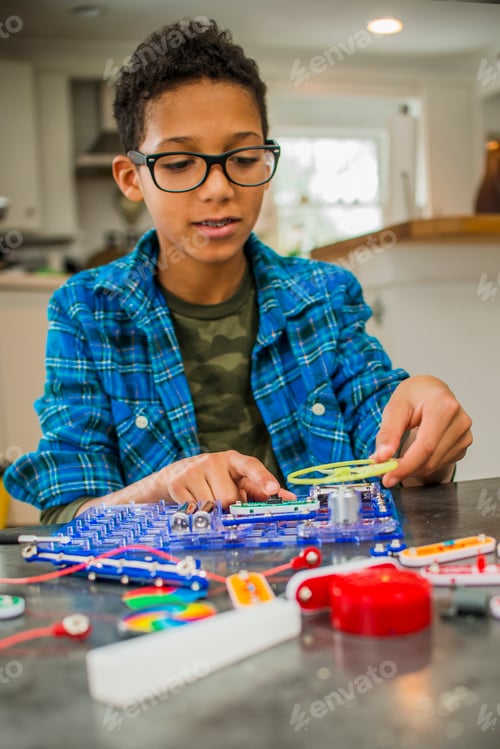 Preview: Boy working on science project at home