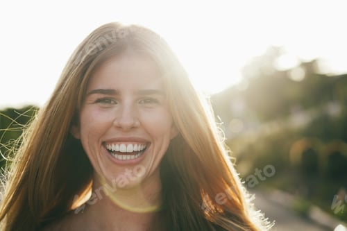 Preview: Young girl smiling on camera having fun outdoor in the city - Focus on face