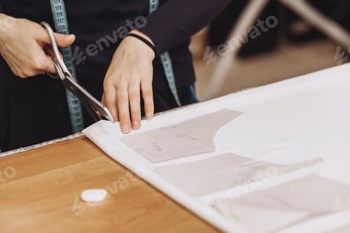 Preview: The tailor cuts out the fabric according to the pattern. Profession of tailor and cutter