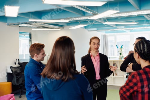 Preview: A diverse team of young business people exchanging ideas in a modern startup office