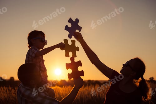 Preview: Happy family playing at the park at the sunset time.