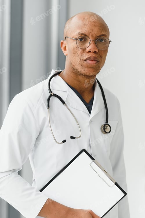 Preview: African American man male hospital doctor in white coat with stethoscope.